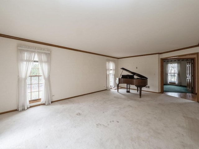 unfurnished living room featuring baseboards, plenty of natural light, and carpet floors