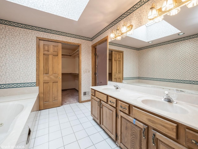 full bath featuring a sink, wallpapered walls, and a skylight