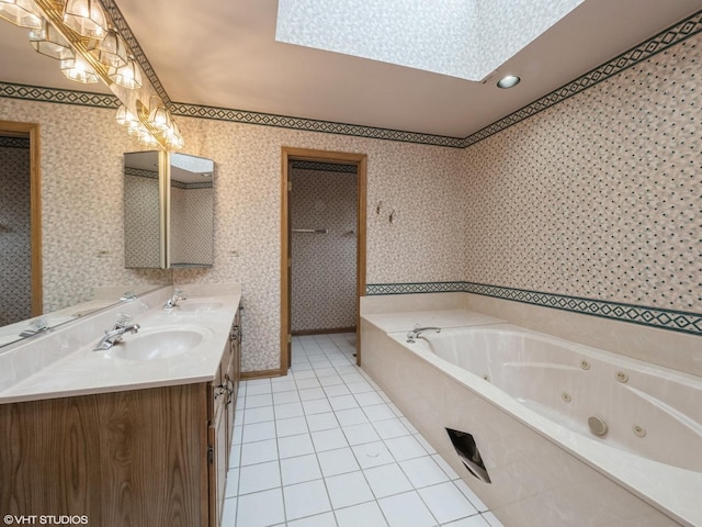 bathroom with a sink, a skylight, and wallpapered walls