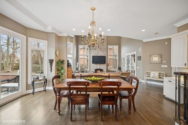 4020 Noble Ct, Northbrook, IL 60062 - dining area with a chandelier, a stone fireplace, dark wood-style flooring, ornamental molding, and baseboards
