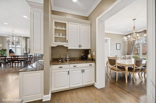 4020 Noble Ct, Northbrook, IL 60062 - bar featuring a chandelier, wood finished floors, ornamental molding, decorative light fixtures, and recessed lighting