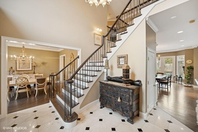 4020 Noble Ct, Northbrook, IL 60062 - stairway featuring a chandelier, baseboards, ornamental molding, recessed lighting, and tile patterned floors
