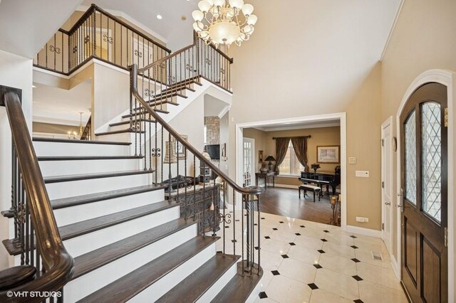 4020 Noble Ct, Northbrook, IL 60062 - foyer with a chandelier, a towering ceiling, stairway, and baseboards