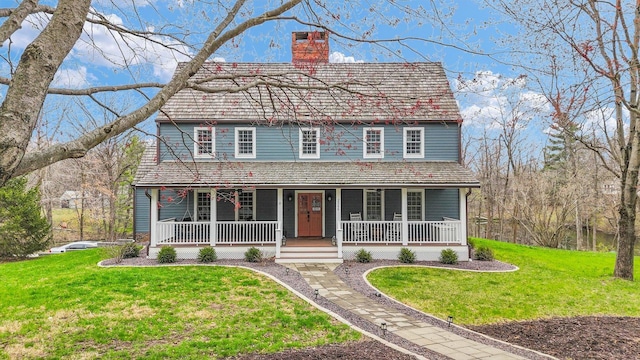 2066 County Road 125 E, Mahomet, IL 61853 - view of front facade with a front yard, a porch, and a chimney