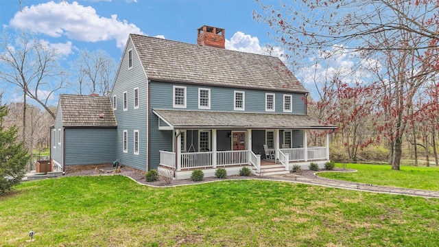 2066 County Road 125 E, Mahomet, IL 61853 - view of front of property with a front lawn, covered porch, and a chimney