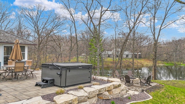 2066 County Road 125 E, Mahomet, IL 61853 - view of patio / terrace featuring outdoor dining area, a fire pit, a hot tub, and a water view