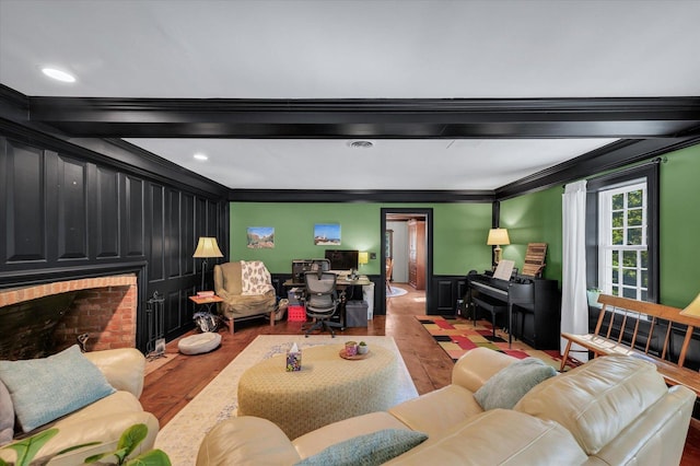 2066 County Road 125 E, Mahomet, IL 61853 - living area with ornamental molding, a wainscoted wall, a brick fireplace, beamed ceiling, and wood finished floors