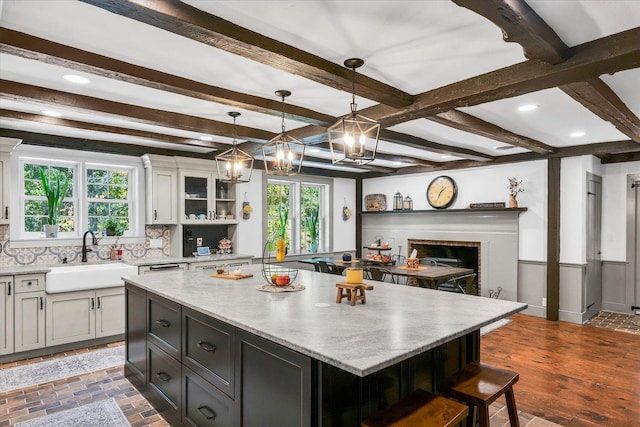 2066 County Road 125 E, Mahomet, IL 61853 - kitchen with a wealth of natural light, tasteful backsplash, a sink, and beam ceiling
