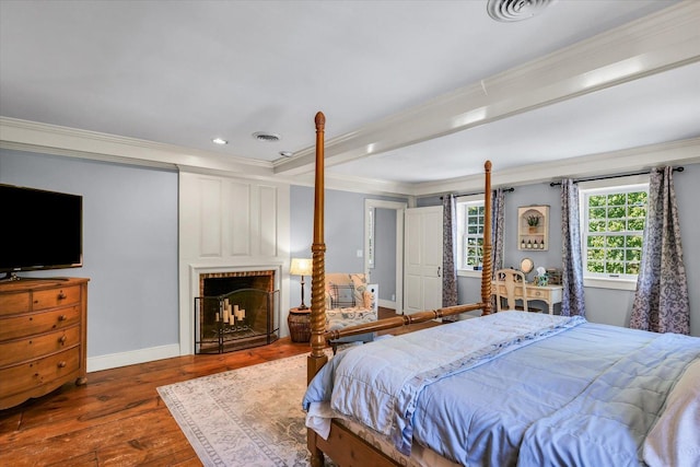 2066 County Road 125 E, Mahomet, IL 61853 - bedroom featuring visible vents, baseboards, a fireplace, crown molding, and wood-type flooring