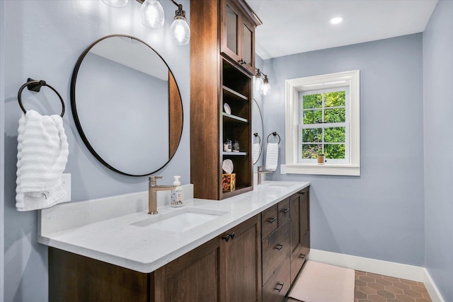 2066 County Road 125 E, Mahomet, IL 61853 - bathroom featuring double vanity, a sink, baseboards, and recessed lighting