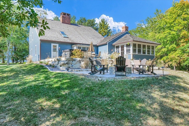 2066 County Road 125 E, Mahomet, IL 61853 - back of property with a patio area, a yard, a sunroom, and a chimney