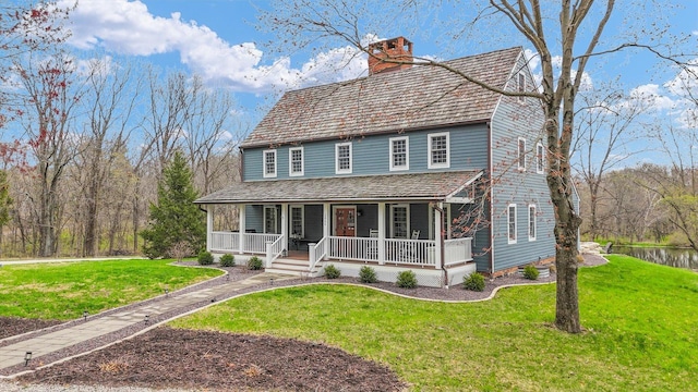 2066 County Road 125 E, Mahomet, IL 61853 - view of front of property featuring a porch, a front lawn, and a chimney