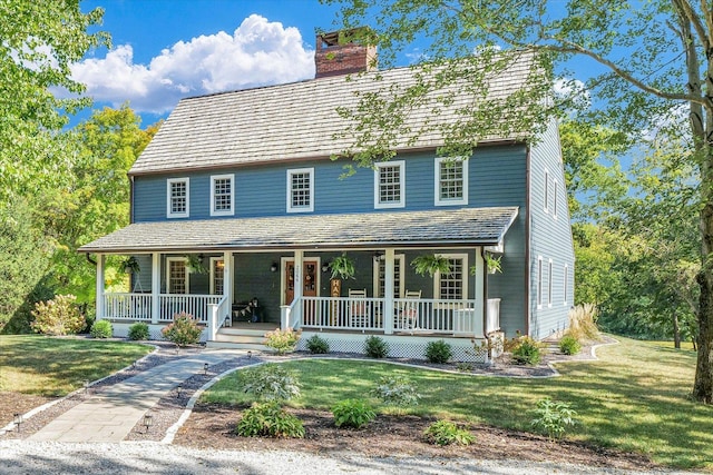 2066 County Road 125 E, Mahomet, IL 61853 - view of front of home with a front lawn, covered porch, and a chimney