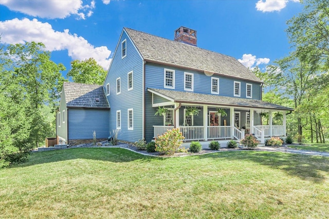 2066 County Road 125 E, Mahomet, IL 61853 - view of front facade featuring a front lawn, covered porch, and a chimney
