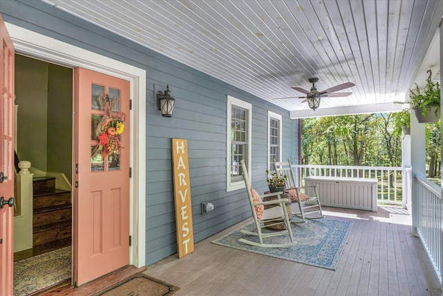2066 County Road 125 E, Mahomet, IL 61853 - wooden deck featuring radiator heating unit, covered porch, and ceiling fan