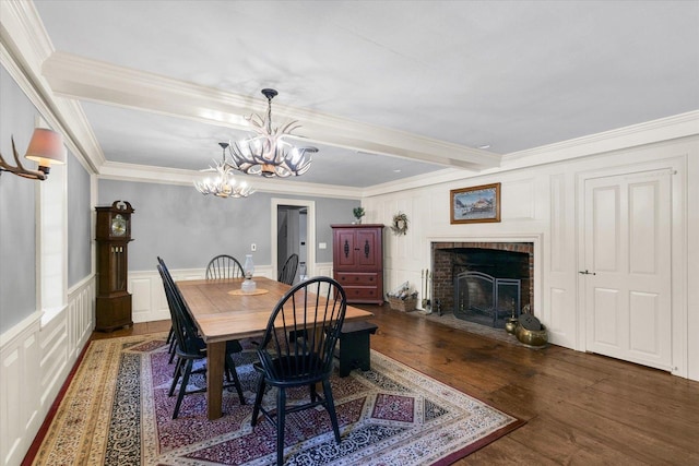 2066 County Road 125 E, Mahomet, IL 61853 - dining space featuring an inviting chandelier, a brick fireplace, a decorative wall, ornamental molding, and wood-type flooring