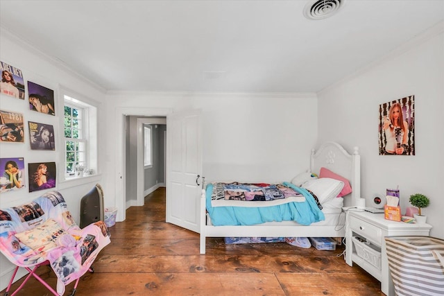 2066 County Road 125 E, Mahomet, IL 61853 - bedroom with wood-type flooring, visible vents, and ornamental molding