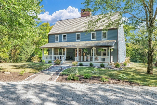 2066 County Road 125 E, Mahomet, IL 61853 - view of front of home featuring a porch, a front lawn, and a chimney