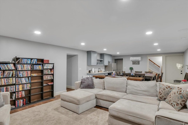 2066 County Road 125 E, Mahomet, IL 61853 - living room with a wall mounted AC, wood finished floors, recessed lighting, and stairway