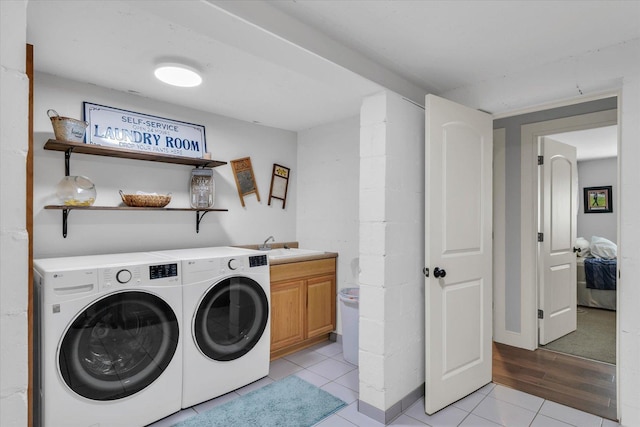 2066 County Road 125 E, Mahomet, IL 61853 - clothes washing area featuring washer and dryer, light tile patterned floors, a sink, and cabinet space