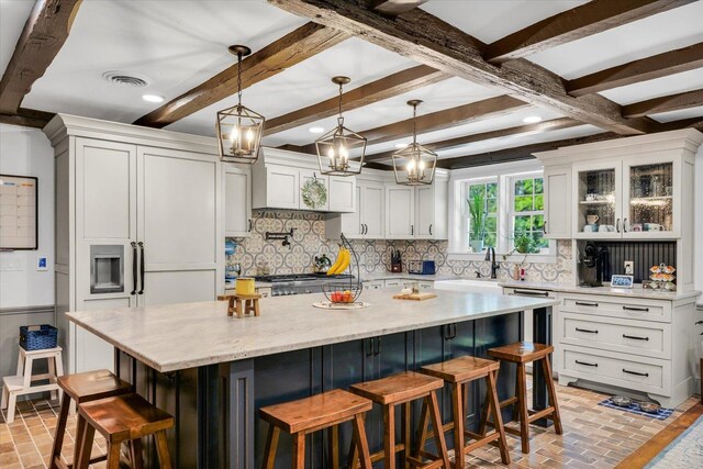 2066 County Road 125 E, Mahomet, IL 61853 - kitchen with visible vents, white cabinets, and decorative backsplash