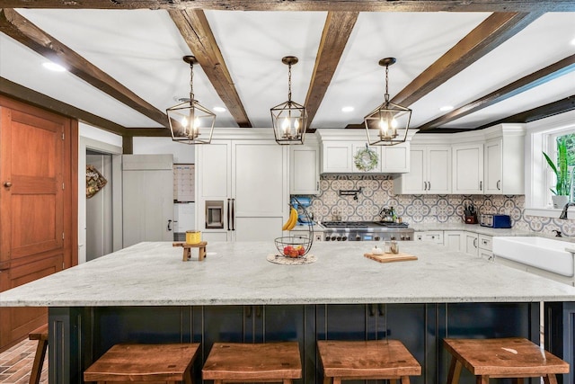 2066 County Road 125 E, Mahomet, IL 61853 - kitchen with range, tasteful backsplash, a sink, and white cabinetry