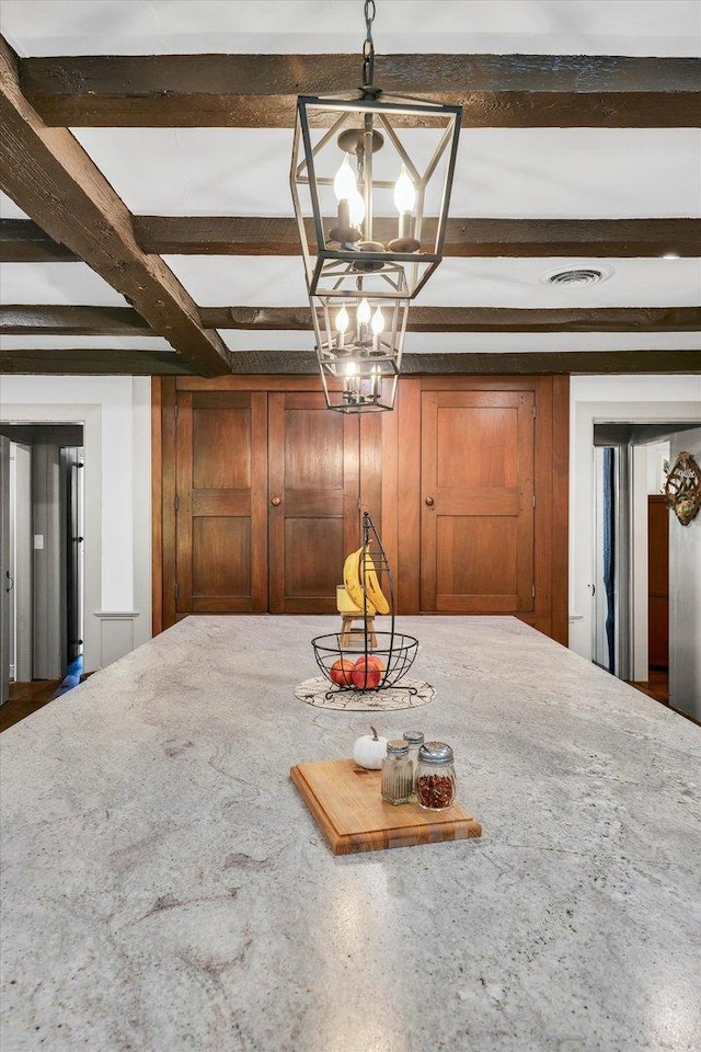 2066 County Road 125 E, Mahomet, IL 61853 - unfurnished dining area featuring wooden walls, beamed ceiling, a chandelier, and visible vents