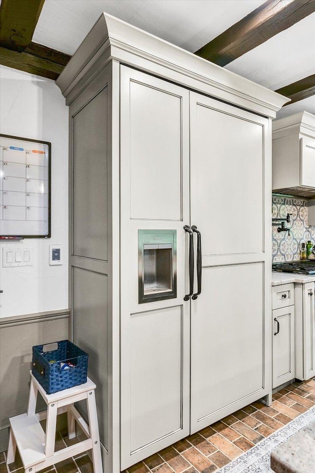 2066 County Road 125 E, Mahomet, IL 61853 - kitchen with tasteful backsplash, light countertops, stainless steel gas cooktop, beamed ceiling, and brick floor