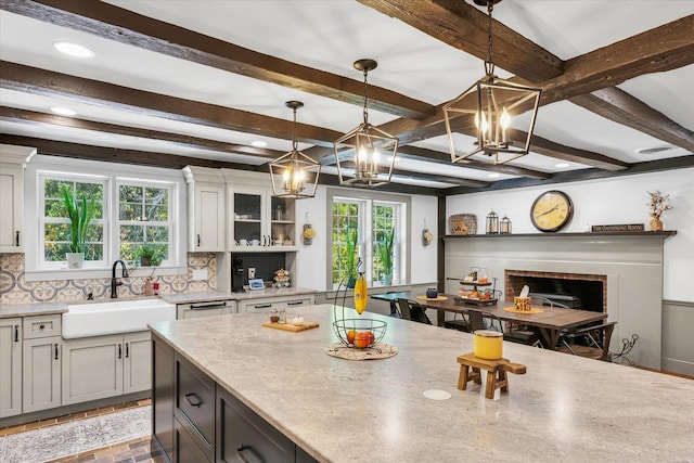 2066 County Road 125 E, Mahomet, IL 61853 - kitchen with an inviting chandelier, white cabinetry, decorative backsplash, a sink, and hanging light fixtures