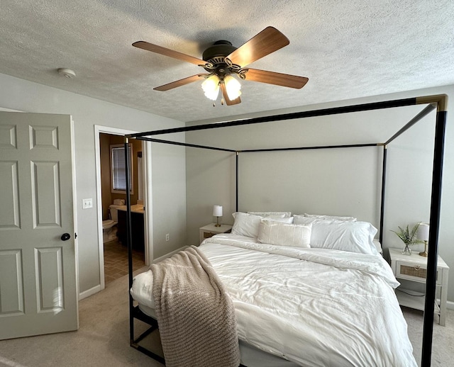 bedroom with light colored carpet, ceiling fan, and a textured ceiling
