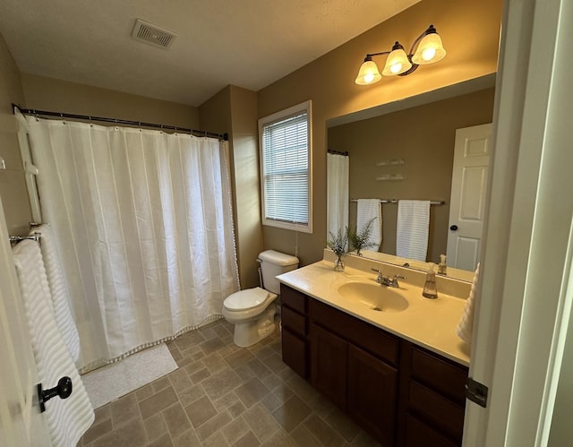 bathroom with a shower with curtain, toilet, vanity, and visible vents
