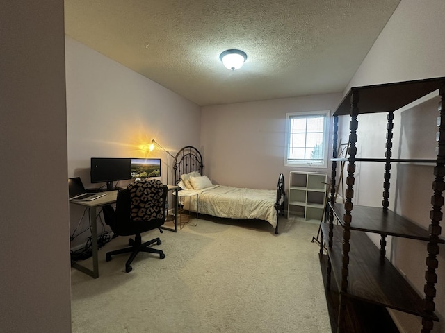 bedroom featuring carpet floors and a textured ceiling