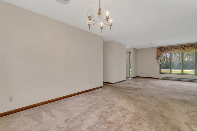 5815 E S Prairie Dr, Morris, IL 60450 - unfurnished room featuring baseboard heating, a chandelier, carpet flooring, and baseboards