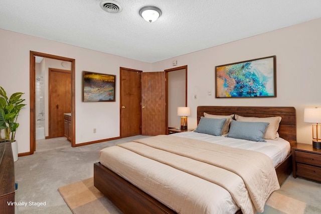 5815 E S Prairie Dr, Morris, IL 60450 - bedroom featuring light colored carpet, baseboards, a textured ceiling, a closet, and connected bathroom
