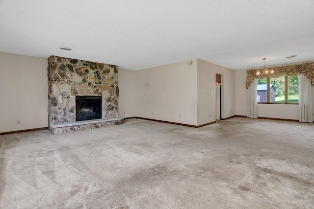 5815 E S Prairie Dr, Morris, IL 60450 - unfurnished living room featuring a chandelier, a stone fireplace, baseboards, carpet, and a textured ceiling