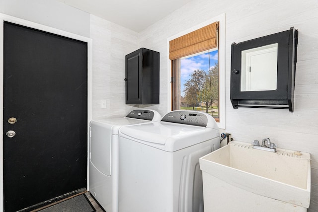 laundry area with laundry area, washer and clothes dryer, a sink, and electric panel