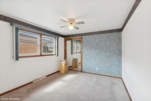 605 Saginaw Ave, Calumet City, IL 60409 - unfurnished bedroom with carpet flooring, a ceiling fan, baseboards, and visible vents