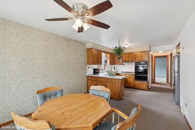 605 Saginaw Ave, Calumet City, IL 60409 - kitchen with freestanding refrigerator, a warming drawer, a peninsula, brown cabinets, and ceiling fan