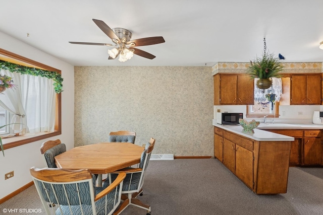 605 Saginaw Ave, Calumet City, IL 60409 - dining area featuring baseboards, wallpapered walls, light colored carpet, and a ceiling fan