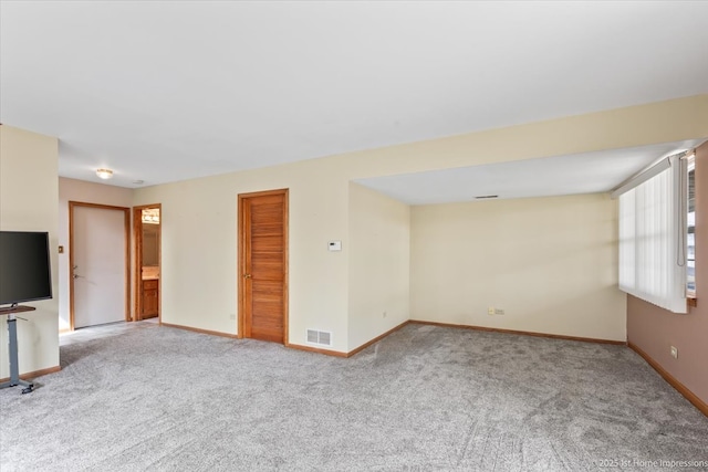 unfurnished living room featuring carpet, baseboards, and visible vents