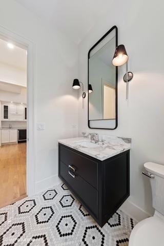 260 E Grantley Ave, Elmhurst, IL 60126 - bathroom featuring baseboards, toilet, vanity, and wood finished floors