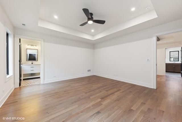 260 E Grantley Ave, Elmhurst, IL 60126 - unfurnished bedroom with baseboards, wood finished floors, recessed lighting, and a raised ceiling