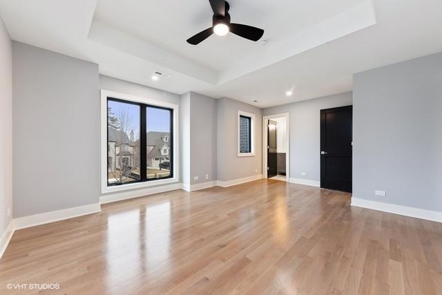 260 E Grantley Ave, Elmhurst, IL 60126 - spare room with baseboards, ceiling fan, light wood-type flooring, and a raised ceiling