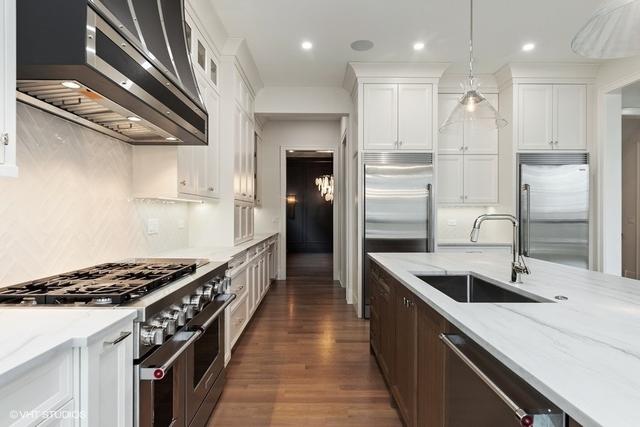 260 E Grantley Ave, Elmhurst, IL 60126 - kitchen with white cabinetry, a sink, high quality appliances, light stone countertops, and ventilation hood