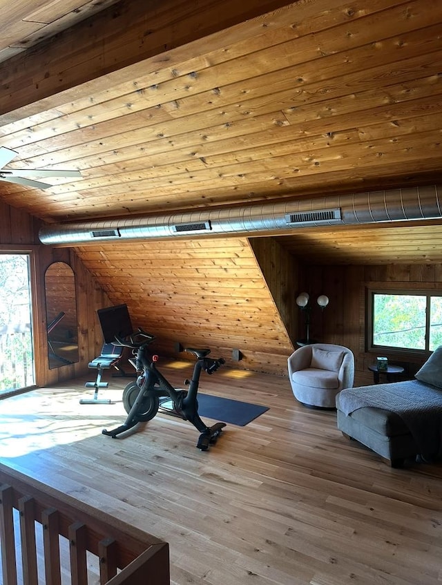 interior space featuring visible vents, wooden walls, wood finished floors, and wooden ceiling