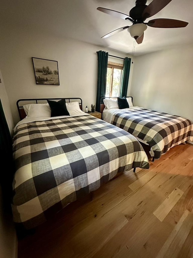 bedroom with wood finished floors and ceiling fan