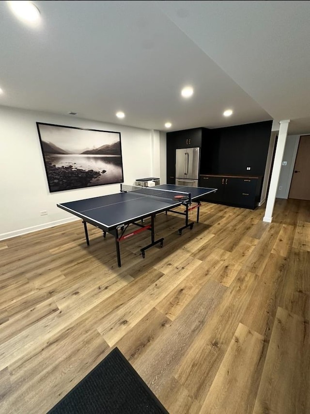 playroom with recessed lighting, baseboards, and light wood-type flooring