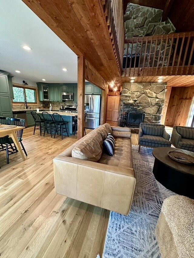 living room with light wood-style flooring and a fireplace