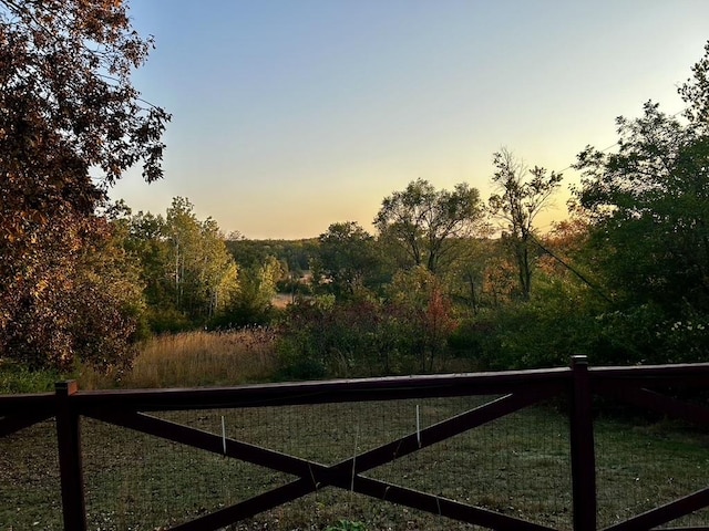 gate at dusk featuring fence