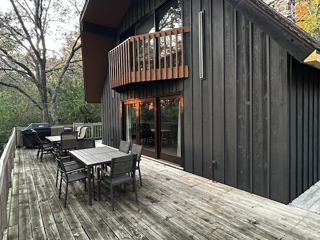 deck with area for grilling and outdoor dining space